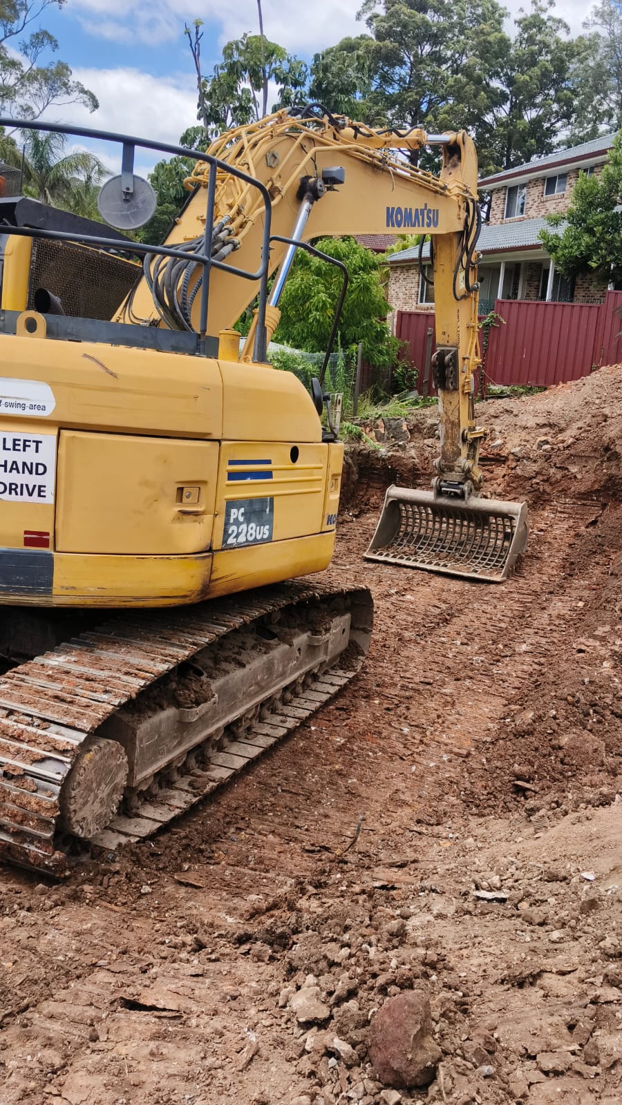 Komatsu excavator excavating residential block